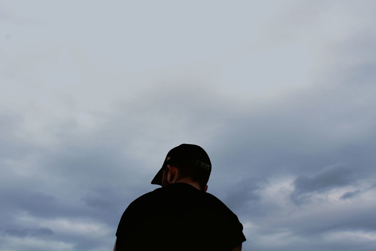 sky, cloud - sky, one person, lifestyles, real people, men, low angle view, leisure activity, silhouette, rear view, nature, standing, waist up, headshot, outdoors, portrait, day, males