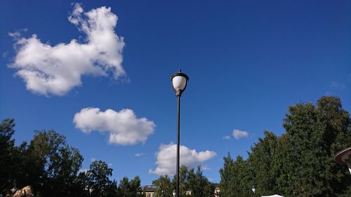 Low angle view of street light against blue sky