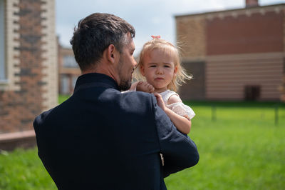 Father and daughter standing outdoors
