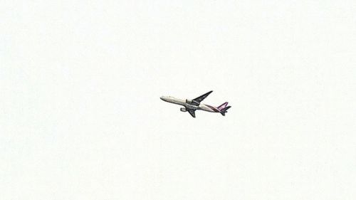 Low angle view of airplane flying against sky