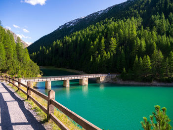 Scenic view of river by mountains against sky