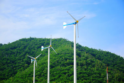 Windmill on field against sky