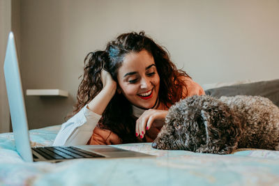 Happy woman lying down on bed