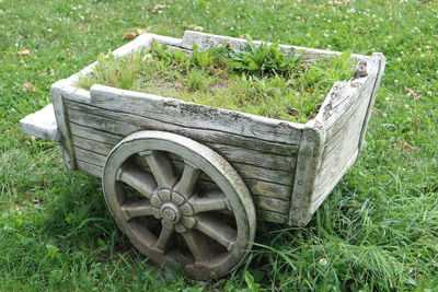 Abandoned wooden structure on grassy field