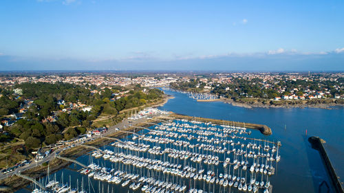 High angle view of cityscape by sea against sky