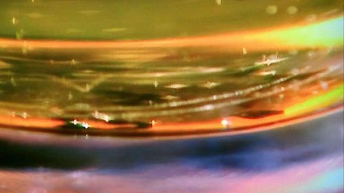 Close-up of glass with reflection on table