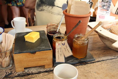 High angle view of butter on cutting board by honey in jar