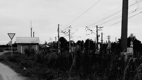 Electricity pylon on field against sky