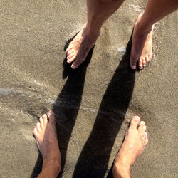 Low section of woman standing on tiled floor