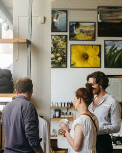 Rear view of people standing at home