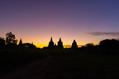 Silhouette of building against sky during sunset