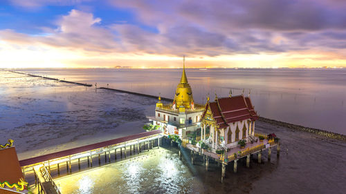 High angle view of city at waterfront during sunset