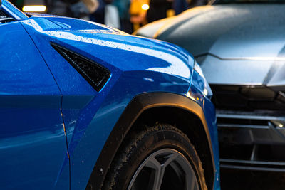 Close-up of blue car on street