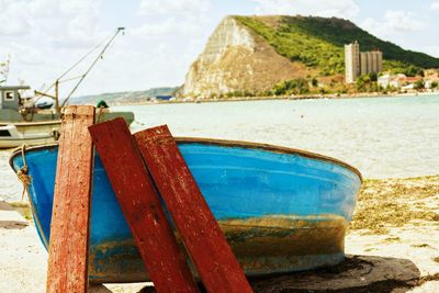 Close-up of boat moored on beach