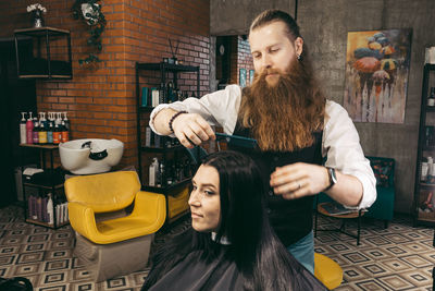 Portrait of smiling young woman using mobile phone