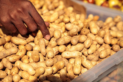 Close-up of person preparing food at market stall