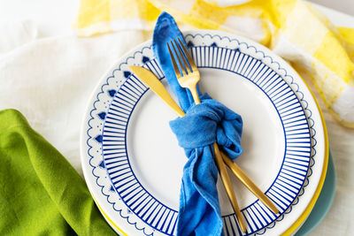 High angle view of hand holding tape measure on table