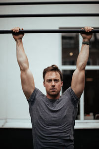 Portrait of confident man exercising in gym