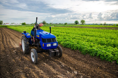 Kherson oblast, ukraine - may 29, 2021 senior farmer works in the field on a tractor