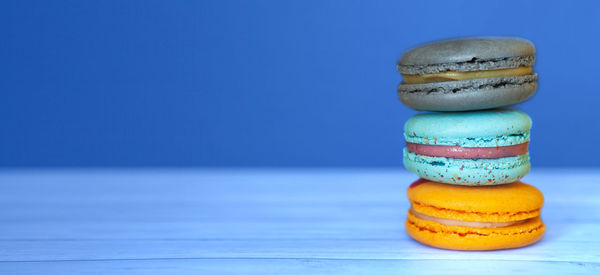 Close-up of cupcakes on table against blue background