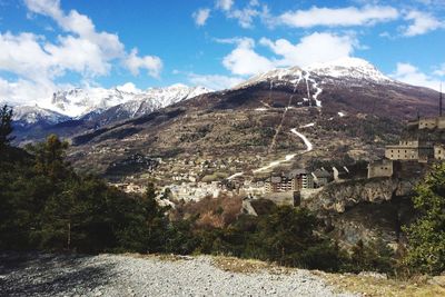 Scenic view of mountains against cloudy sky