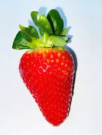 Close-up of strawberry over white background