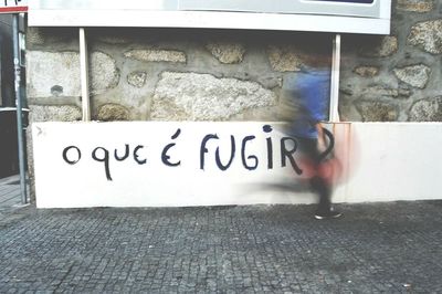 Man and text on wall