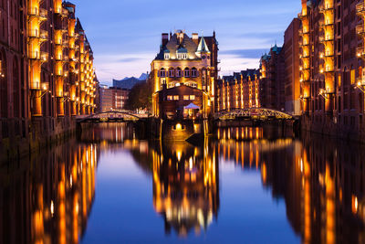 Reflection of buildings in city at night