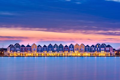 Huts by sea against sky