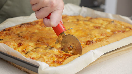 Cropped hand of person preparing food