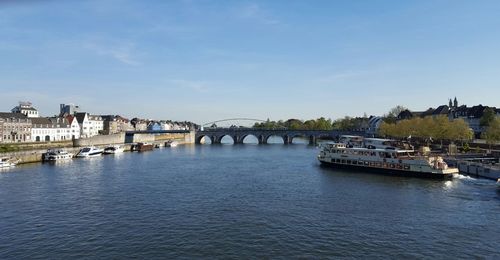 Boats in river with buildings in background