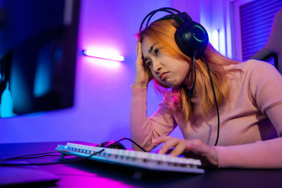 Young woman using mobile phone at home