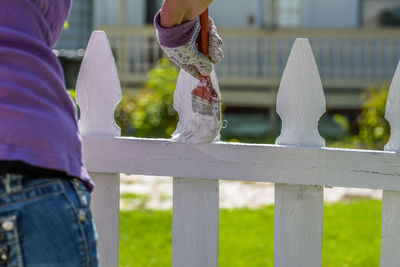 Low section of woman on railing