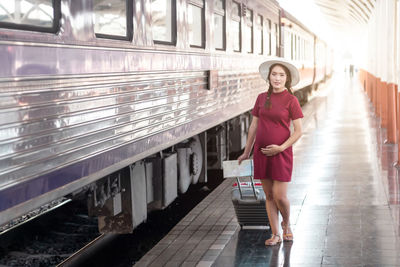 Full length of woman standing in train