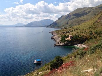 High angle view of bay and mountains against sky