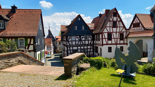 Houses against sky on sunny day