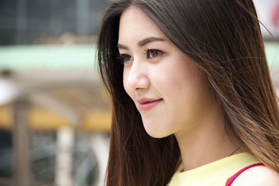 Side view of smiling young woman