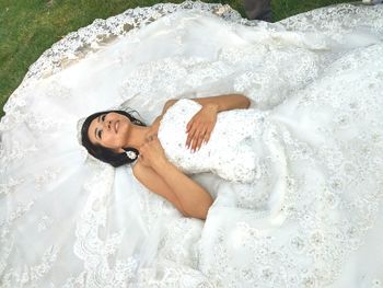 High angle portrait of young woman with tattoo on water