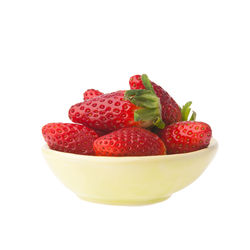 Close-up of strawberries in bowl against white background