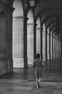 Full length rear view of man walking in building