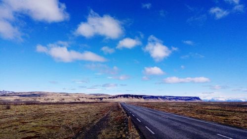 Empty road along countryside landscape