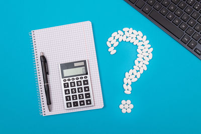 Directly above shot of laptop on table against blue background