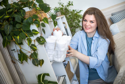 Portrait of smiling young woman using mobile phone