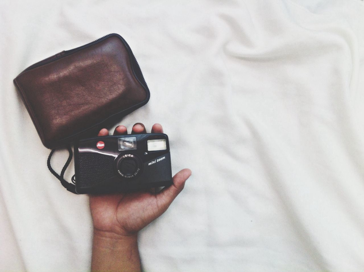 indoors, technology, wireless technology, holding, person, connection, photography themes, close-up, lifestyles, part of, communication, smart phone, leisure activity, mobile phone, photographing, camera - photographic equipment, high angle view