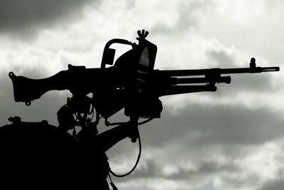 Low angle view of silhouette airplane against sky