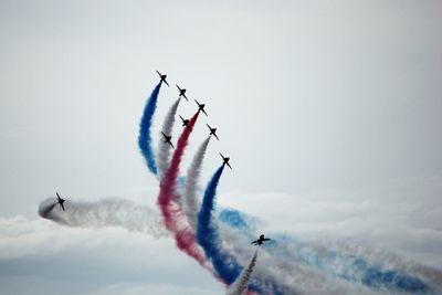 Low angle view of airplane flying against sky