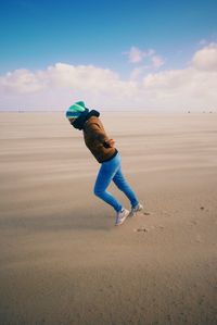 Full length of woman standing on shore