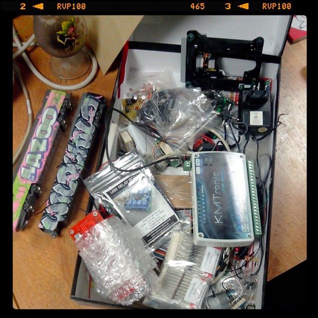 indoors, still life, variation, table, large group of objects, transfer print, high angle view, choice, close-up, auto post production filter, arrangement, no people, technology, abundance, collection, group of objects, equipment, bottle, book, fork