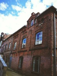 Low angle view of abandoned building against sky