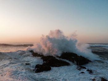 View of waves breaking on rocks